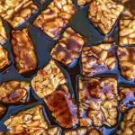 Smoky Marinated Tempeh - tempeh cubes marinating in a savory brown sauce.